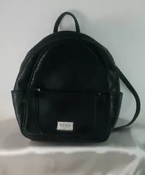Guess“G” LogoTextured Black Faux Leather Small Backpack PurseFront Zipper PocketTwo Side PocketsOne Top Handle and...