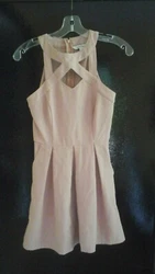 Its a dusty pink, pink/beige. Has cute side pockets. Classy & cute!