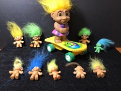 1 3” Troll on a 5” Yellow Skateboard. 5 Miniature Troll Dolls 1”. 2 Halloween Lapel Pins, with Pumpkin Bag. Each...