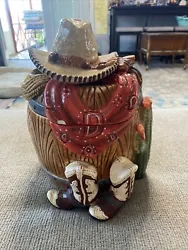 Vintage Western Cookie Jar. This cute cookie jar with western theme is used. With minor chips is in the pictures....