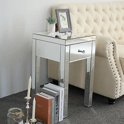 This unique mirrored nightstand or bedside table with one drawer is sure to add sparkle to your bedroom. The Mirrored...
