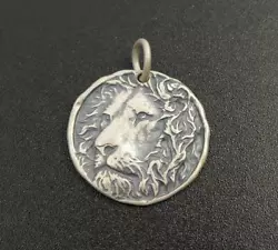 Handmade sterling silver disc pendant featuring lion head design. Amazing details! The surface is gently brushed and...