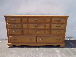 Traditional Style 11 Drawer Dresser. Shows surface wear and needs to be refinished. Ideal candidate to paint for a...