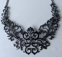 This Necklace will look great on an open neckline. A bold black cutout scroll style really shows off the design.