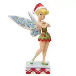Wearing a dashing red and green rosemaled dress the fairy rocks a Santa hat with sassy style. With delicate wings she...