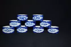 These are a very old set of 9 porcelain hand painted blue on white napkin rings or chop stick holders. Each has a...