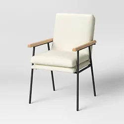 •Metal-frame dining chair adds sleek style to your interiors •Wooden arm elevates the look •Cream upholstery with...