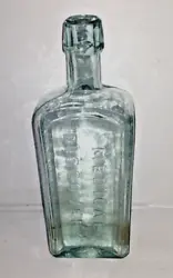 Large antique medicine bottle.  Applied lip.  Embossed lettering on three sides.  Bubbles