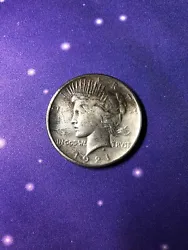 This 1921 United States silver dollar features a stunning image of Lady Liberty on one side and a majestic eagle on the...