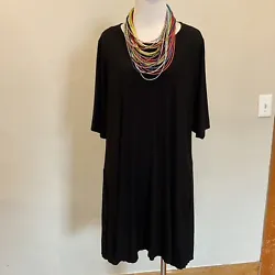 Eileen Fisher black jersey swing dress with inseam pockets and short sleeves. Gently worn and in good preowned...