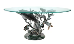 This beautiful coffee table features a brass dolphin and sea life stand, with a marble base, and has a glass table top....