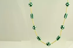 REALLY WONDERFUL GREEN WHITE ART GLASS BEADS WITH LONG PLASTIC IN BETWEEN. Form: NECKLACE.