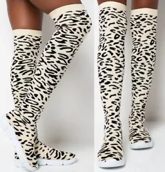 Knee-high sock sneaker in black and white leopard print. Super stretchy fabric for a pull-on fit. 19