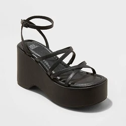 •4in platform-heel sandals •Strappy crisscross upper •Faux-leather construction •Round open-toe and open-back...