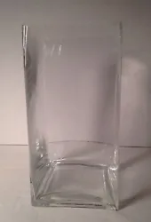 This tall clear glass vase is one of six available. It is 4