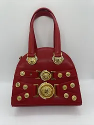 This is a beautiful bag in a bright red color, but there are noticeable signs or being worn including a missing...