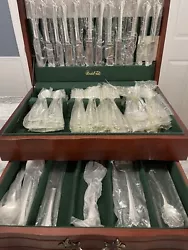 Oneida flatware set for 12, vintage set , 30+ years and still new in original wrapping! The set comes in a wooden box...