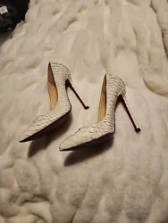 Add a touch of exotic elegance to your shoe collection with these stunning Christian Louboutin Python Heels. The...