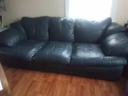 Leather couch. Green leather couch in good condition there is some wear on the back  and side see pictures the front...