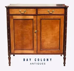 This cabinet has two upper drawers over a double door base. The paneled tiger maple doors open to reveal four sliding...