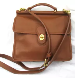 This is an unused Coach Willis bag made in 2000. Not discolored, just impressed.