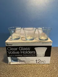 Add a touch of elegance to your home with this set of 12 glass votive candle holders. The round shape and clear color...