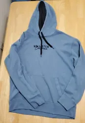 This Hollister hoodie for men is a casual and comfortable blue pullover sweater made from a cotton blend fleece fabric....