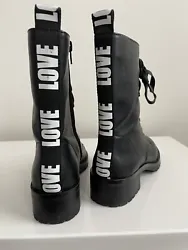 Elevate your style with these black Aldo boots, featuring the word LOVE on the back. Designed for teens, these...