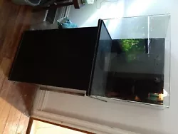 55 gallon fish tank with stand comes with everything in the orange bucket. I currently have a lot of stuff below the...