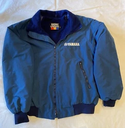 Yamaha Blue. Full Zip Long Sleeve. 3 pockets ( 2 on outside and 1 on inside).