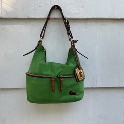 This Dooney & Bourke hobo bag is the perfect accessory for any stylish woman. With a bright green exterior color and...
