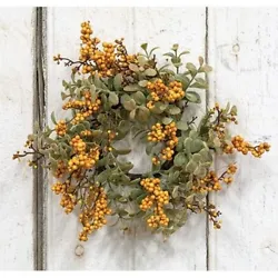 This is a new candle ring wreath of artificial mustard foam berry clusters and eucalyptus leaves.