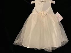 Elegant Infant Girls Marmellata Classics Ivory Wedding Party Dress with netting overlay on skirt. Embellished with a...