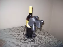 VERY UNIQUE PUPPY DOG WINE BOTTLE HOLDER. ALSO HAS A PLACE FOR THE CORK SCREW, JUST REMOVE THE PUPPYS HEAD. THE BOTTLE...
