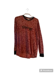 This LuLaRoe tunic top in red is a perfect addition to any wardrobe. The knit fabric is comfortable and the burnout...