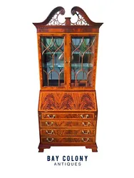 This commanding secretary desk has a lighted interior and mirrored back which makes it closer to a collectors showcase...
