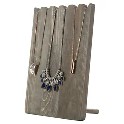 Tabletop wooden necklace display stand with a rustic gray finish. Simple plank-style design, with sawtooth top,...