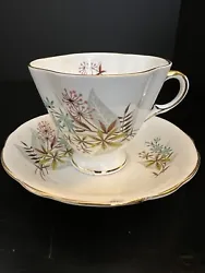 This has a small chip on the base of the cup. The set features a beautiful pattern of leaves in brown and teal blue,...