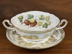 Beautiful double handled cream soup bowl and saucer set by Spode in the Golden Valley pattern. Golden Valley is a...