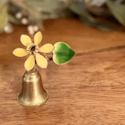 This brass candle snuffer features a beautiful yellow enamel flower and green leaf accent. Its swivel design allows for...