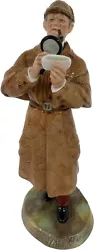 Royal Doulton Figurine The Detective HN 2359 1976 depicts a figure wearing a plaid cap and over-coat reading an...