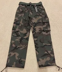 Nathan Cargo Pants. Color: Woodland Green Camouflage. The pants are classic cargo pants with flap cargo pockets.