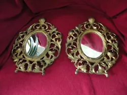 Antique pair of cast iron Art Nouveau gold vanity mirrors. The mirrors have a stand to secure them to the vanity and...