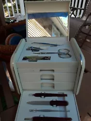 Manicure Set In Plastic Bix With Drawers. The items appear to not have been used. It has a handle for easy carrying