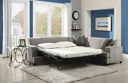 The grey padded seat back of the sofa and chaise feature a pull-out bed with innerspring queen sized mattress for...