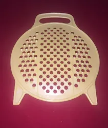 Gold color. Handle and feet so you can stand up or hold directly over the bowl to grate.