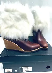 Waterproof, full-grain leather with an oversized faux fur. A dramatic faux fur cuff looks snow-bunny chic. Heel...