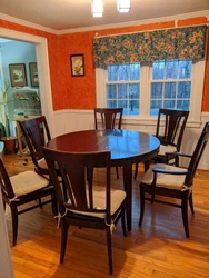 Nichols & Stone round dining table, two leaves. Two captains chairs, six side chairs.  Solid ash, espresso finish. ...