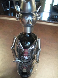 A cowboy who is sporting a gun, lasso and hat. Bottle used as displaying item only and not part of this sale. Great...