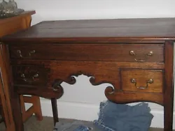 Nice antique desk. I believe it is oak. Could be Mahogony. 3 drawers and some sculpting on front. Very nice finish and...